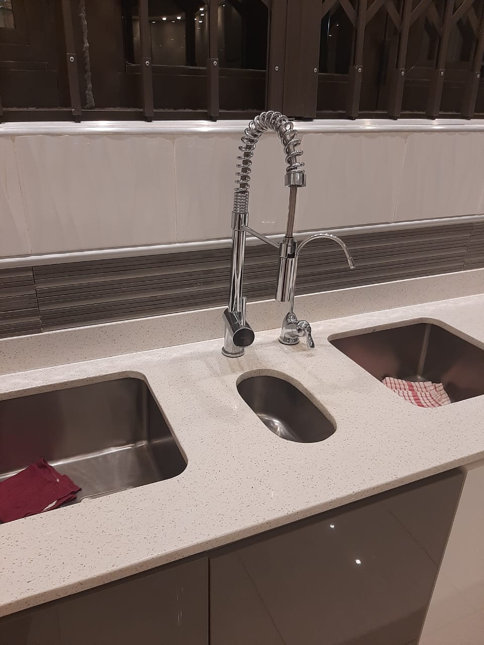 Freestanding bathtub and toilet installed in a newly tiled bathroom