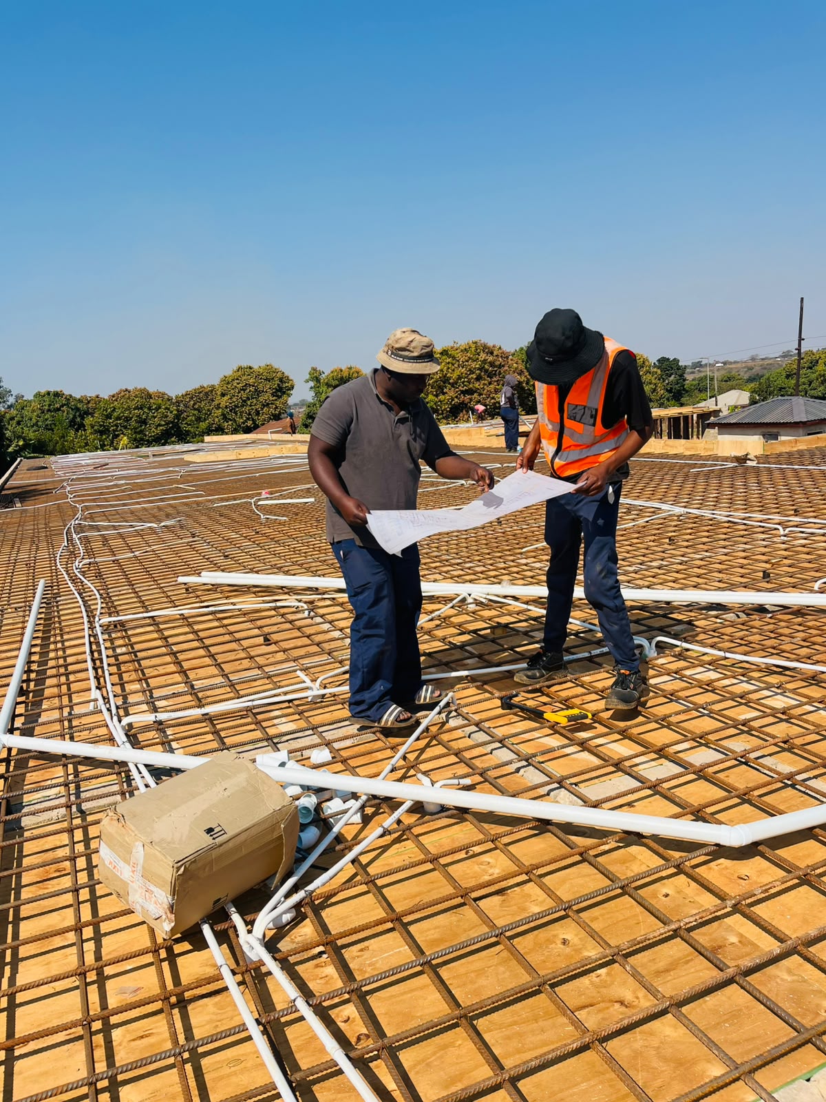 Plumbing pipe layout laid into a concrete slab reinforcement on a new-build roof