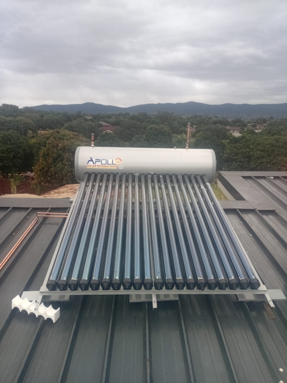 Apollo solar geyser with evacuated tubes installed on a tiled roof overlooking the Vhembe hills