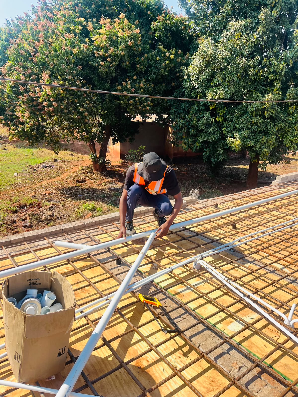 Pfano & Given Plumbing technician laying pipework into a roof slab on site