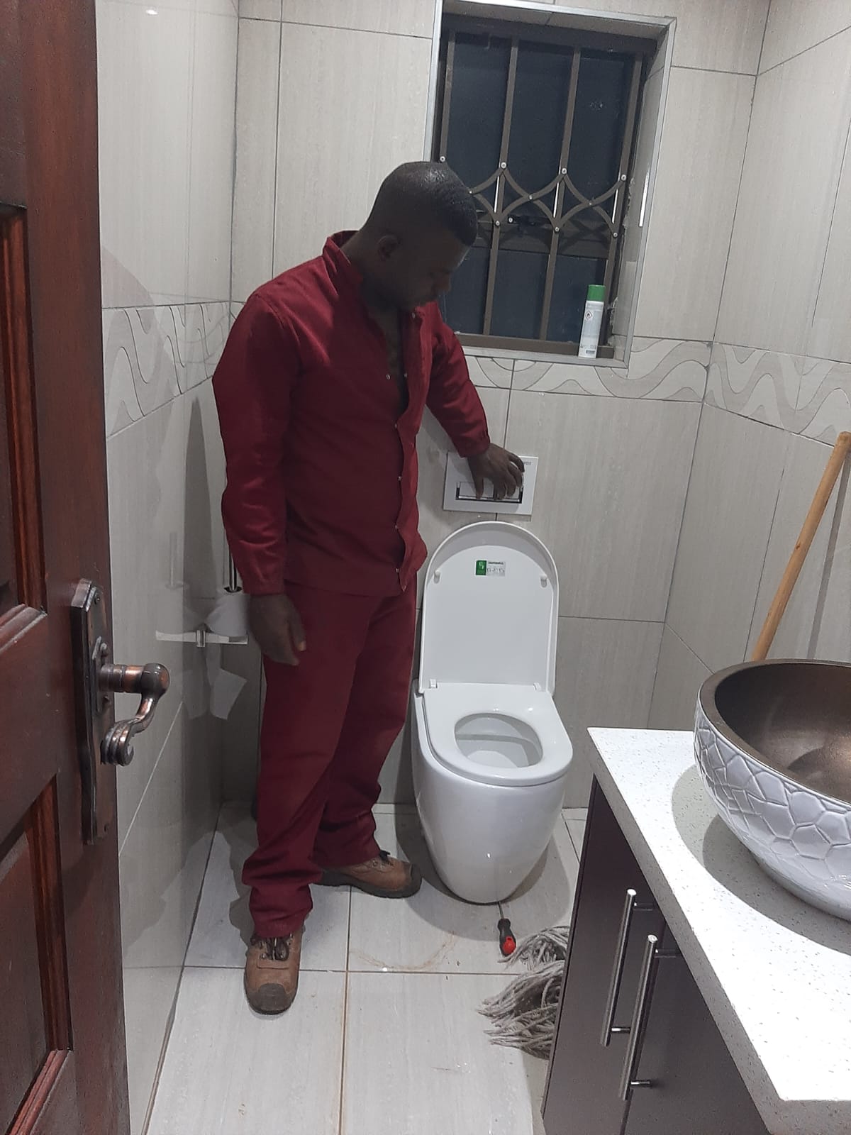 A Pfano & Given Plumbing technician fitting a toilet cistern during an emergency call-out