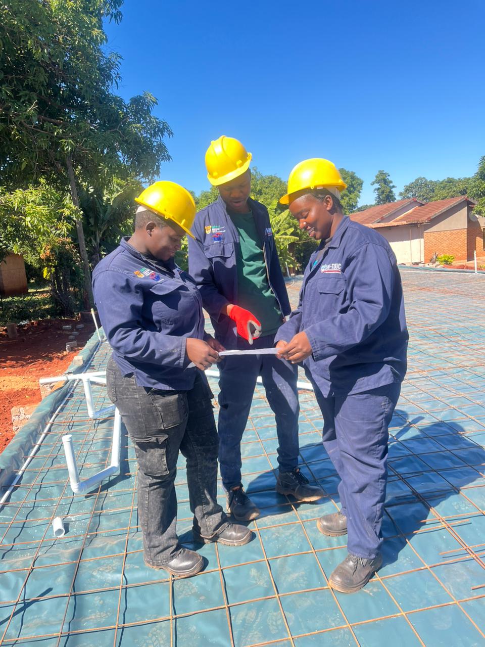 Pfano & Given Plumbing team reviewing plans on site before starting a job